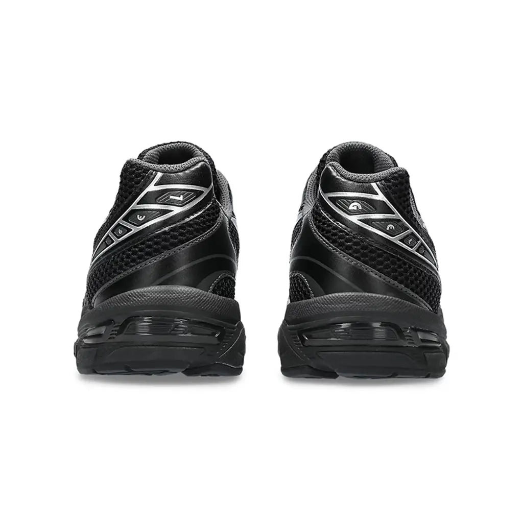 Black athletic shoes with a brand logo on a white background