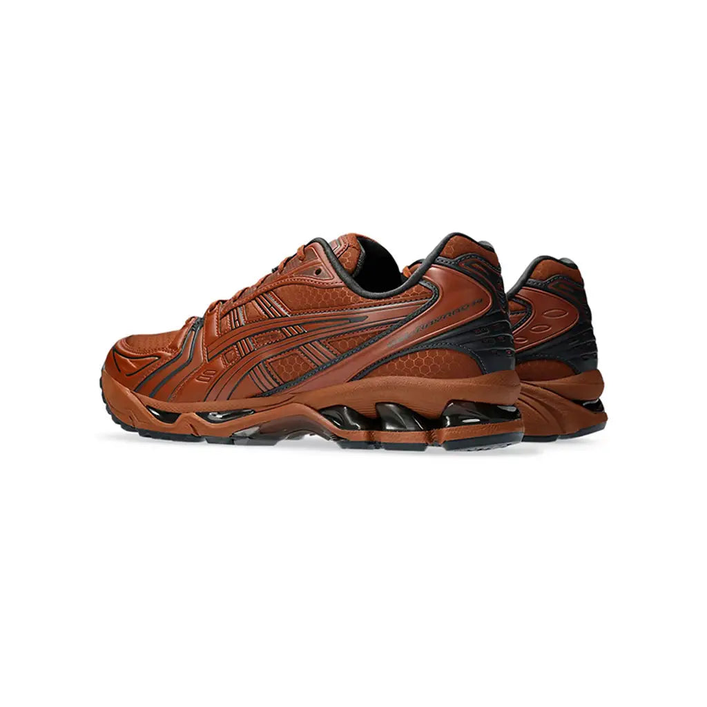 Brown athletic shoes with black accents on a white background