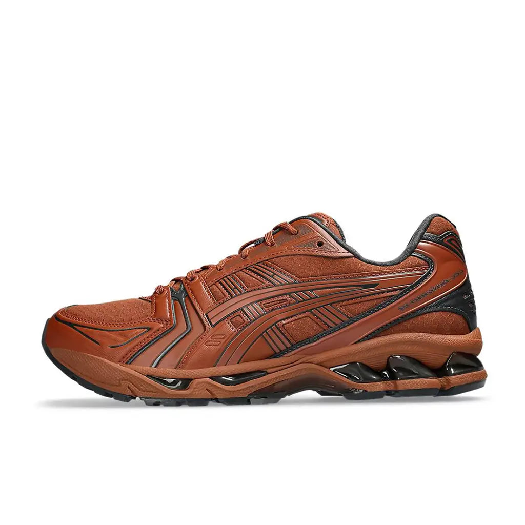 Brown running shoe with black sole on a white background