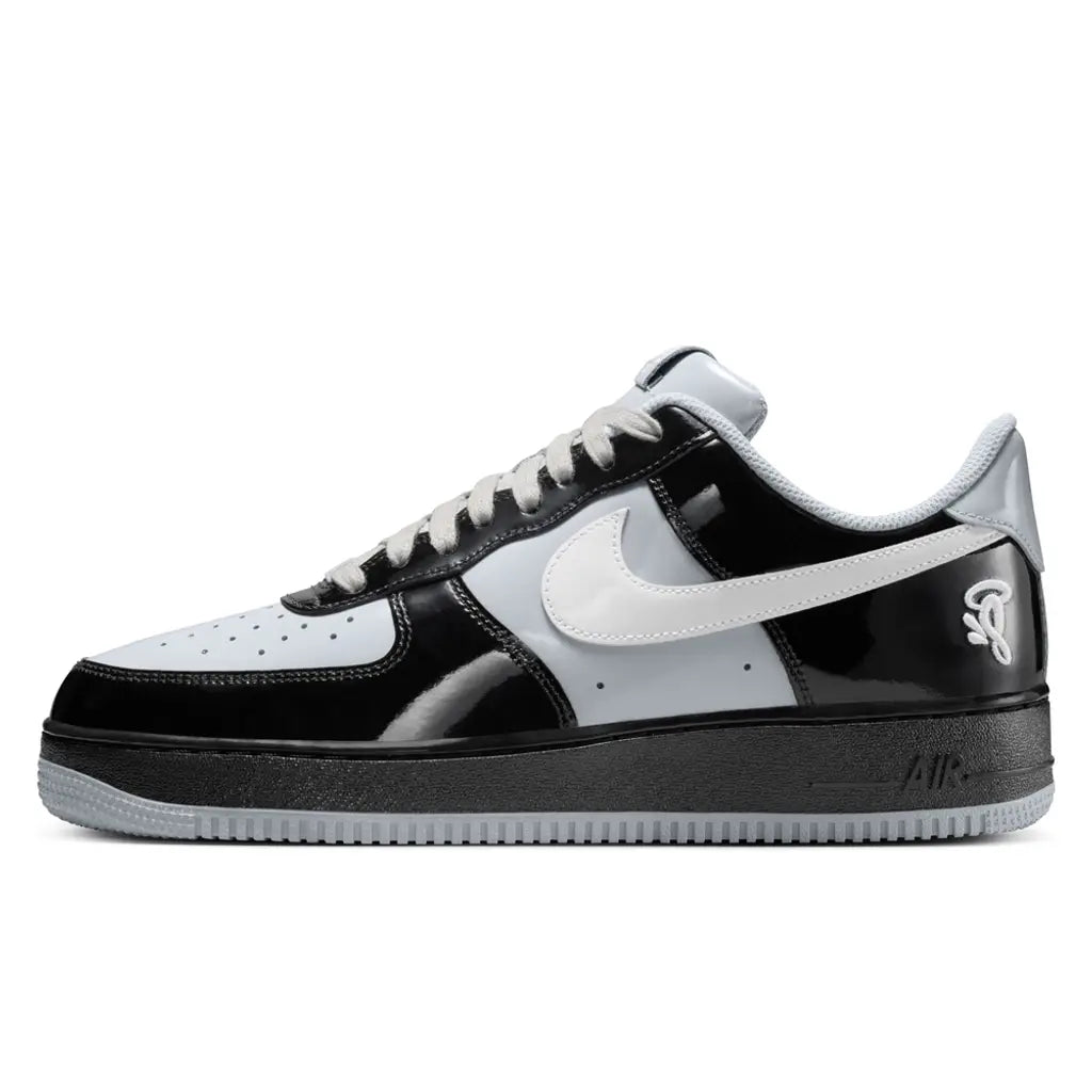 Black and white sneaker with a prominent Nike logo on a white background