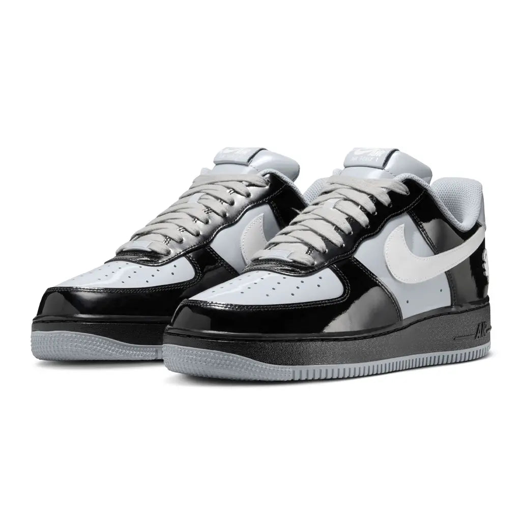 Black and white sneakers with a prominent brand logo on a white background