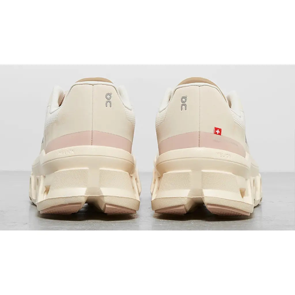 Pair of beige running shoes on a light gray background