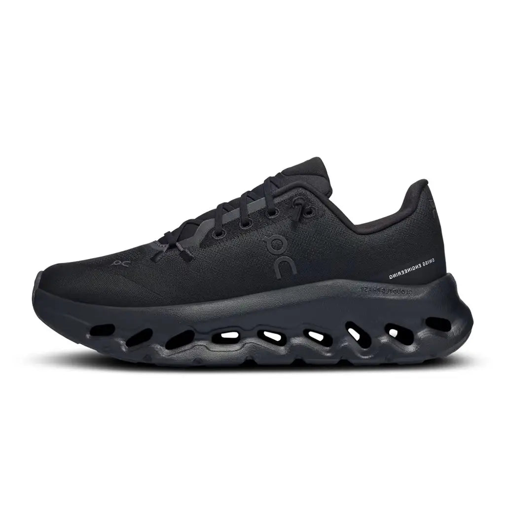 Black soccer cleats with blue accents on a white background